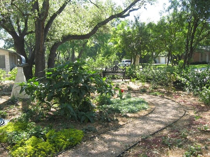 mulch beds with path and bench