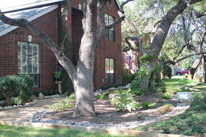 shady traditional front yard, brick house