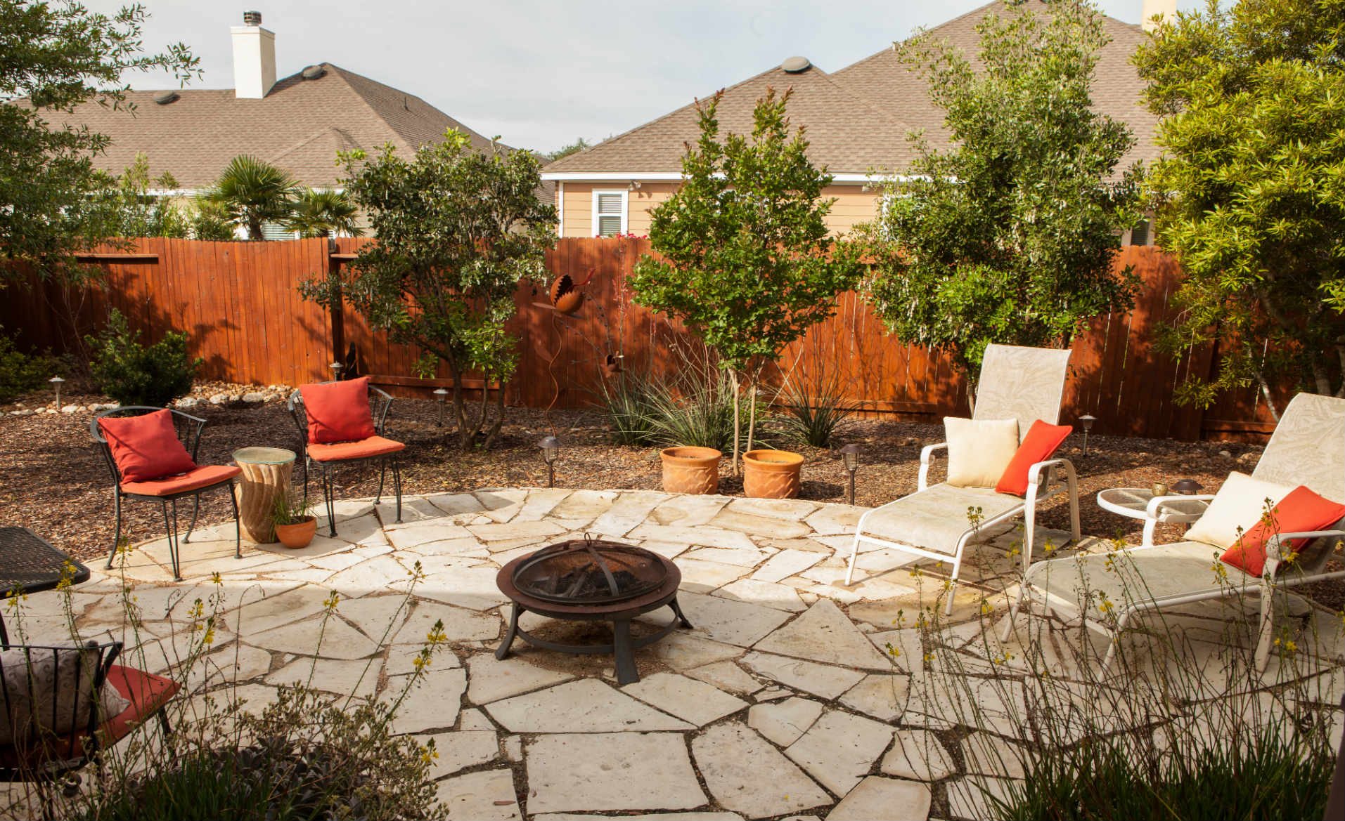 Large flagstone patio with a fire bowl to relax around.