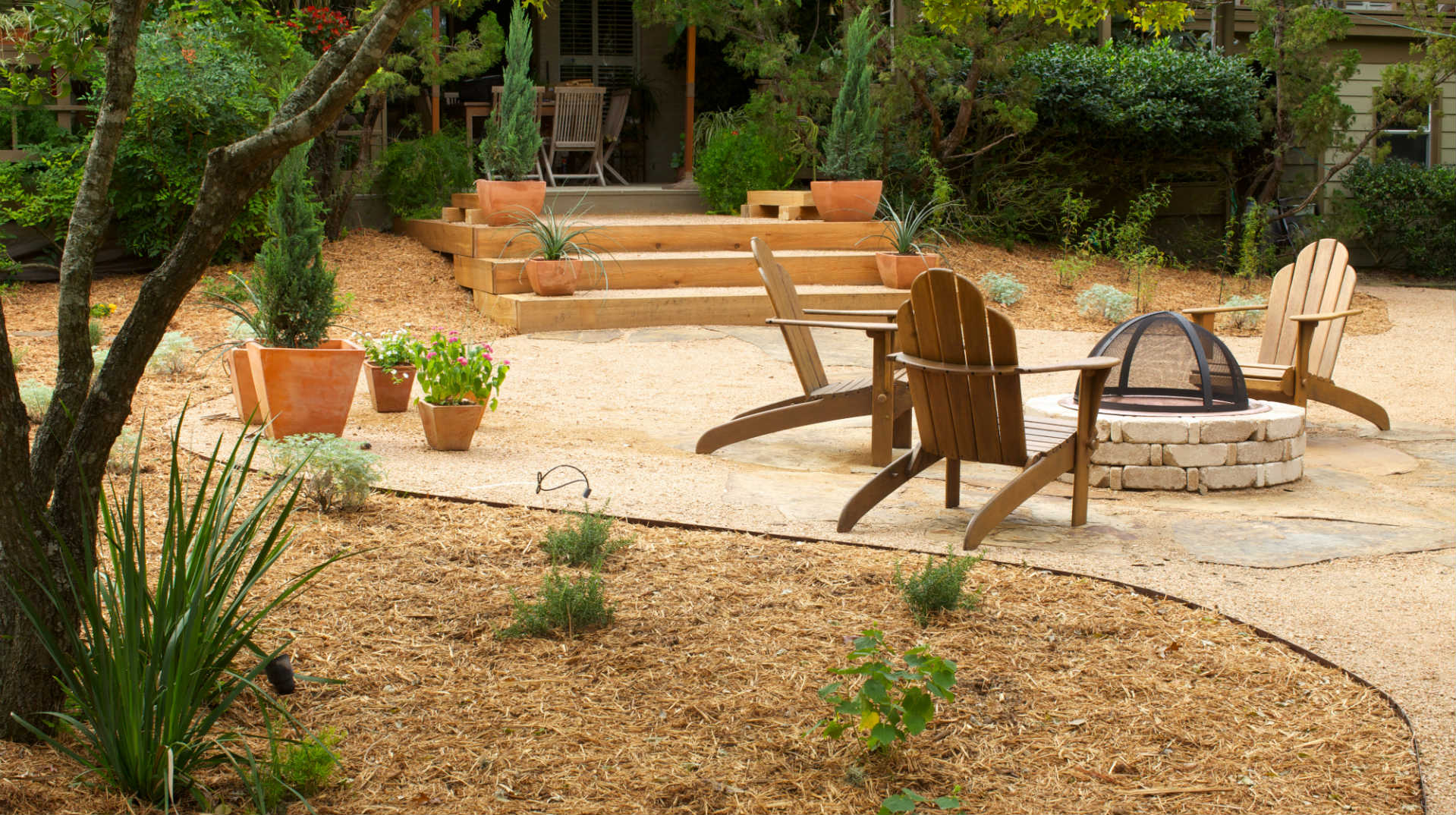 Backyard with clean lines and patio with firepit.