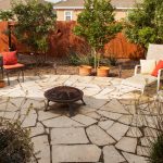 Flagstone patio with firebowl expands backyard living space.