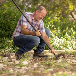 A rock bar helps break up tough, rocky soil.