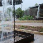Image of rain falling on rain chains and other rainwater collection devices at San Antonio Botanical Garden