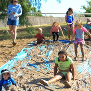 Image showing children and parents playing with mud.