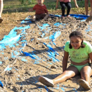 Children sampling a mud slide at San Antonio Botanical Garden