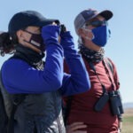 Photo of two people bird watching